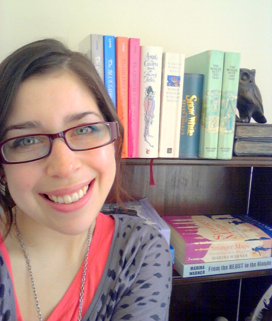 Belinda Calderone smiles in front of bookshelf with owl bookend.