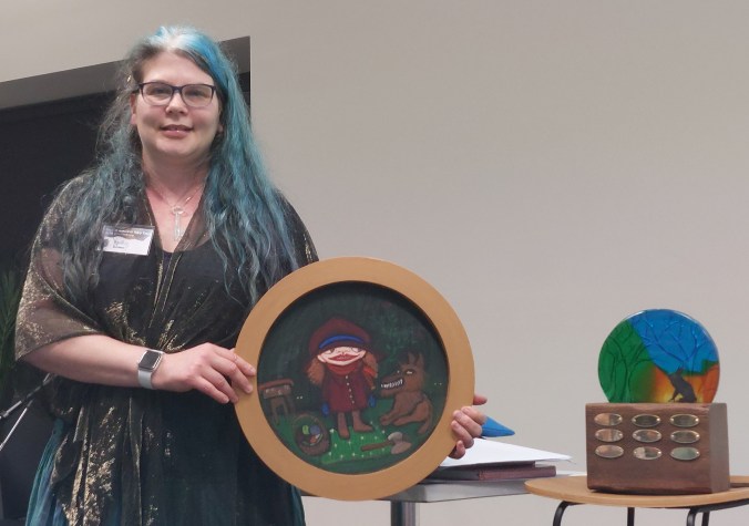 2025 AFTS Award winner Spike Deane, with artwork by Debra Phillips and the Award trophy